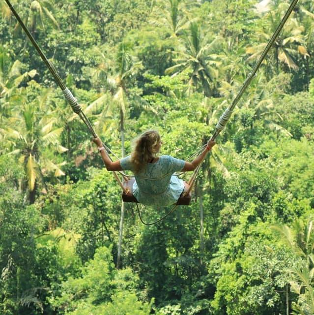Woman on jungle swing, Ubud, Bali, Indonesia